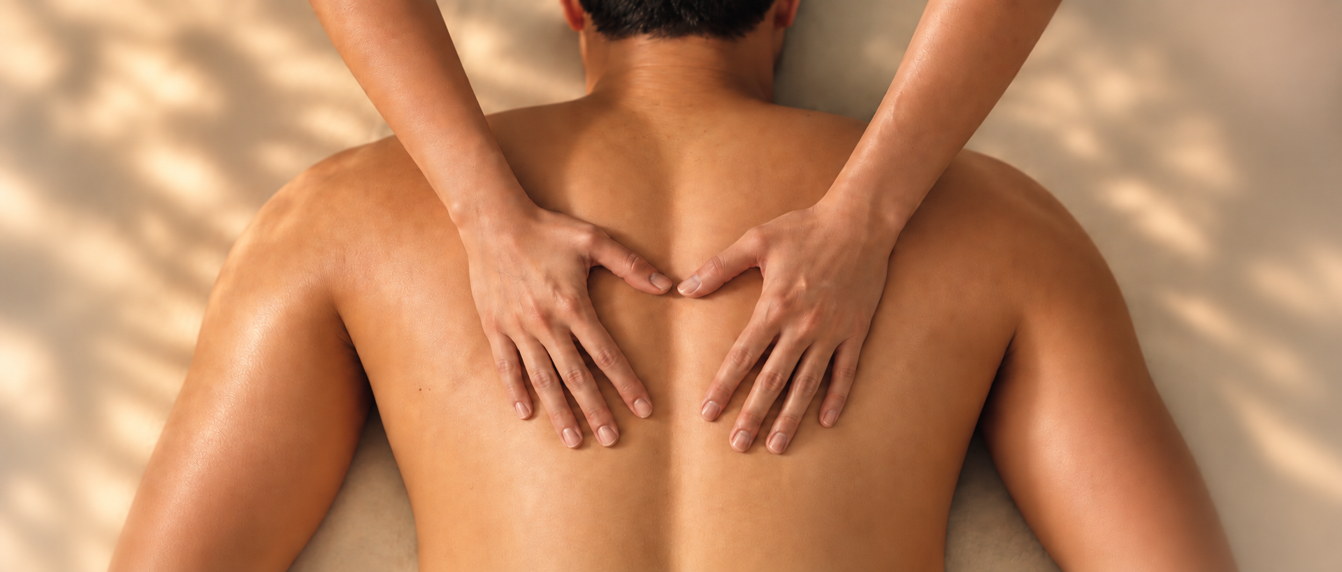 Chi Spa practitioner forms a heart with their hands on a guest's back during massage.